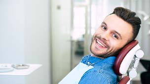 Man smiles after toothache treatment in Phoenix