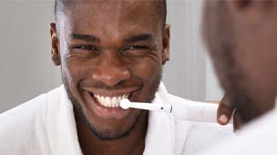 Man brushing his teeth to prevent toothaches in Phoenix