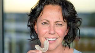 Woman wearing mouthguard to prevent broken tooth in Phoenix