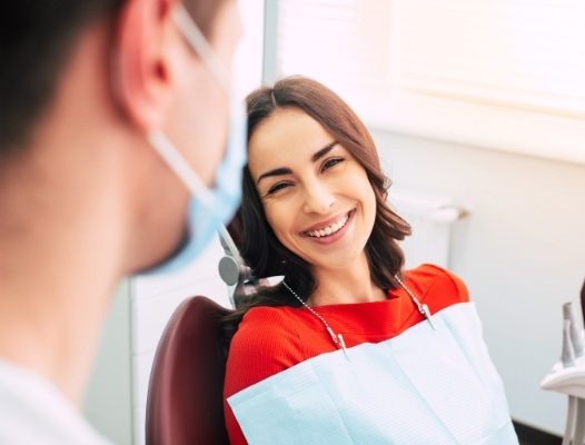 Woman smiling at dentist after root canal therapy