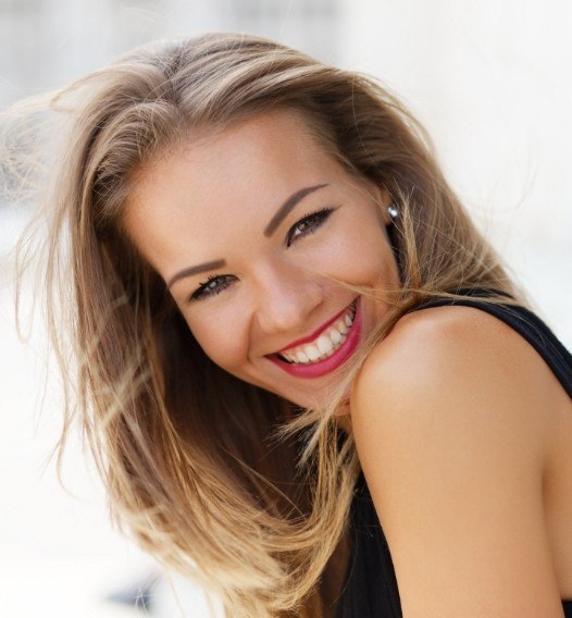 Woman with bright smile after teeth whitening