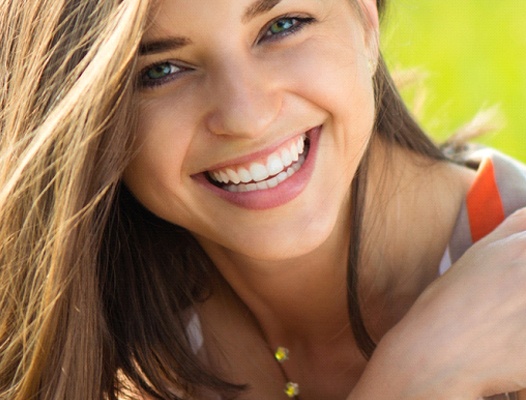 Woman smiling after teeth whitening in Phoenix